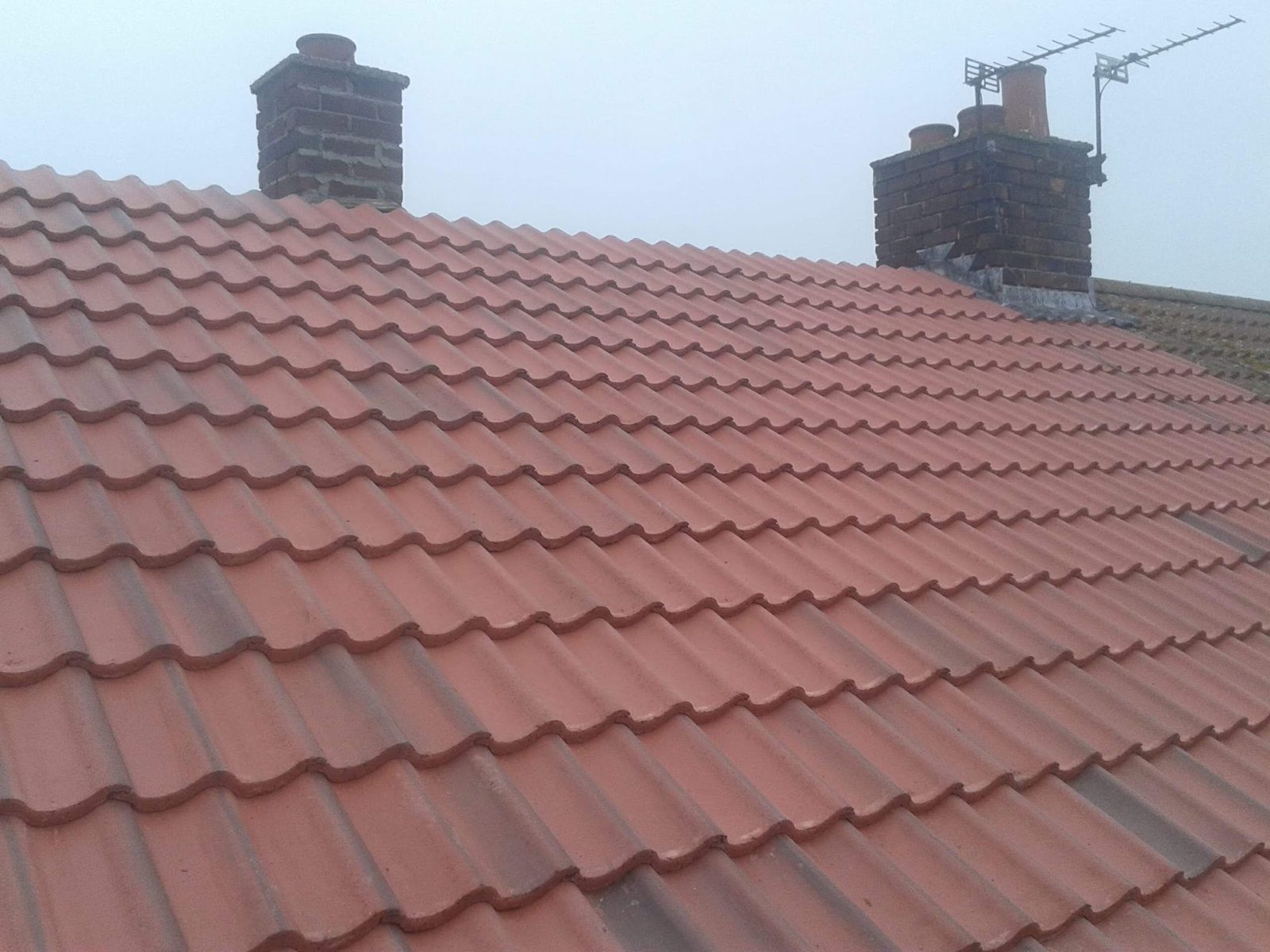 A newly tiled red roof by P & B Roofing