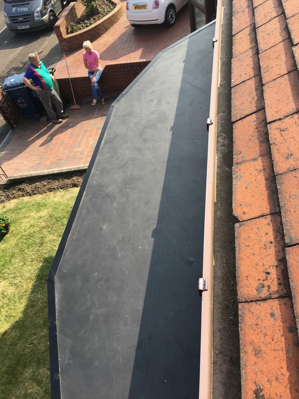 A finished rubber flat roof beside a tiled roof